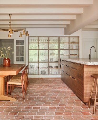 Kitchen of Amsterdam home renovation by Studio Modijefsky with wooden island and dining set-up