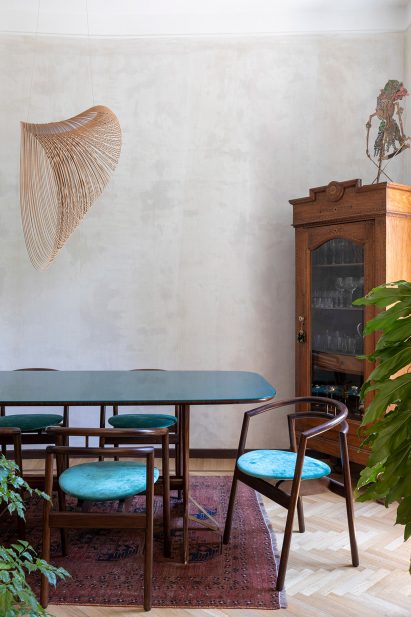 Blue glass-surface dining table in Rome apartment by 02A