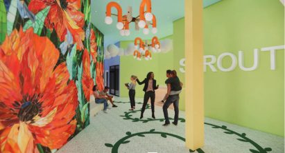 Colourful interior with a wall finished with floral wallpaper by student at Drexel University