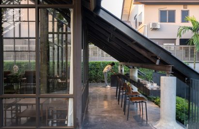 Bar leading to terrace over dog park by ECAR Architects