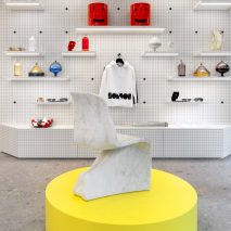 Fabio Novembre stool on yellow display plinth in IoNoi Gallery in Milan