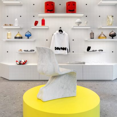 Fabio Novembre stool on yellow display plinth in IoNoi Gallery in Milan