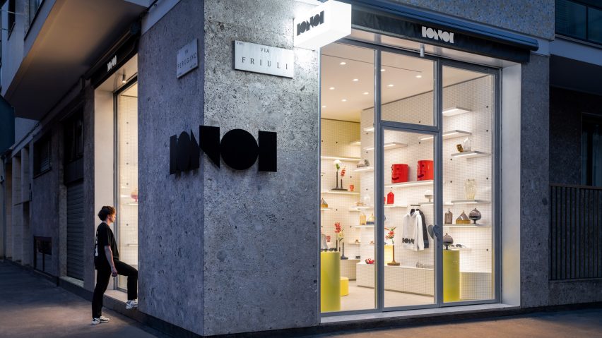 Exterior view of person stepping into Fabio Novembre's IoNoi Gallery in Milan