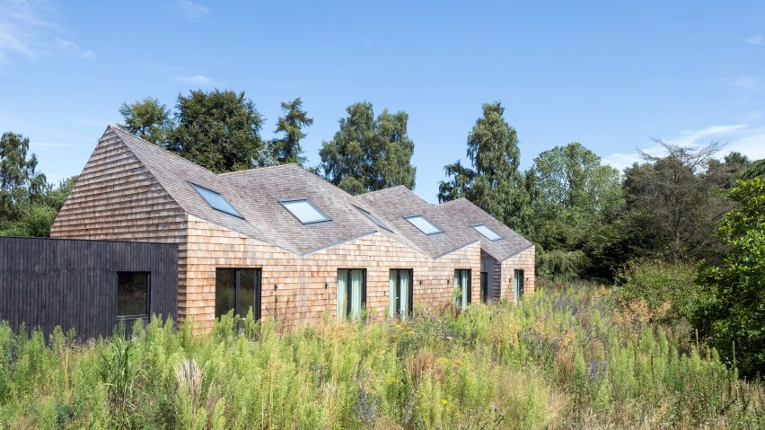 Exterior of angular house with garden in front