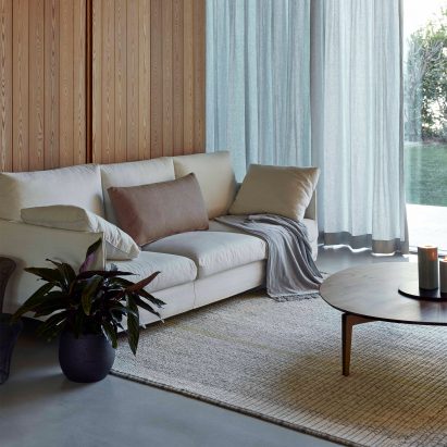 GAN rug in a living room with a cream sofa and wooden coffee table