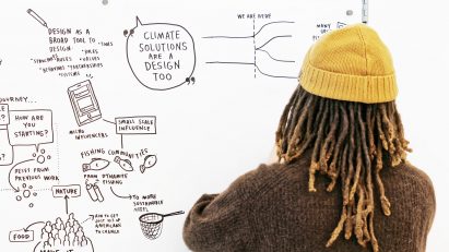 Student at IIT Institute of Design writing a mindmap on a white board