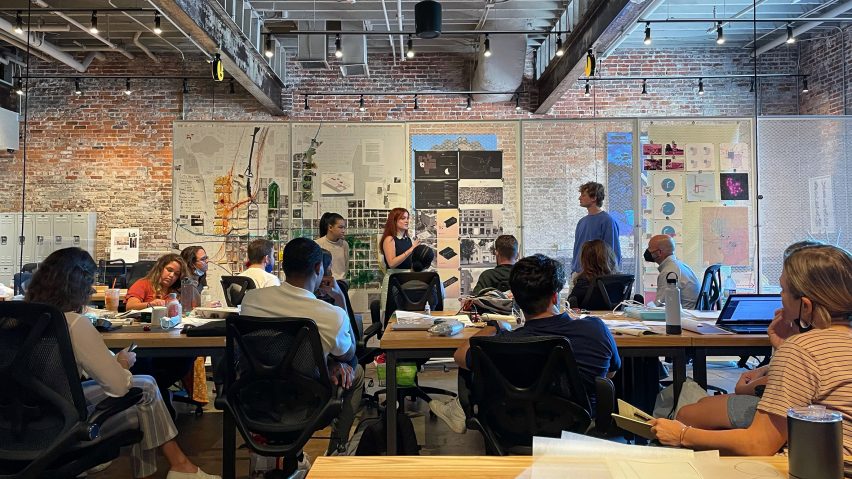 A photograph of people watching a presentation