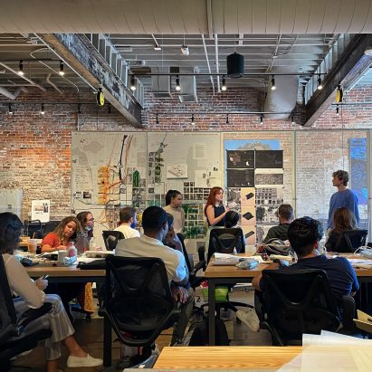 A photograph of people watching a presentation
