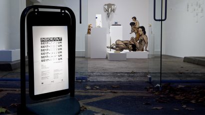 Photograph of advertising board on pavement outside gallery