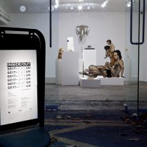 Photograph of advertising board on pavement outside gallery