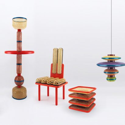 Photograph of furniture including chair, lamps, stool and table on white backdrop