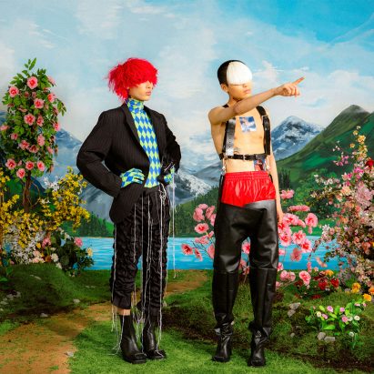 Two models in a grassy and floral set