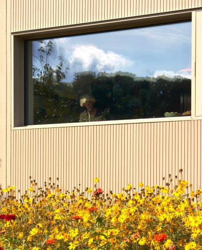 Larch-clad facade with picture window
