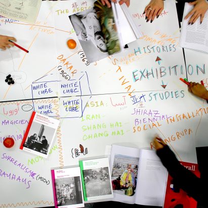 Students around a table annotating a mind map