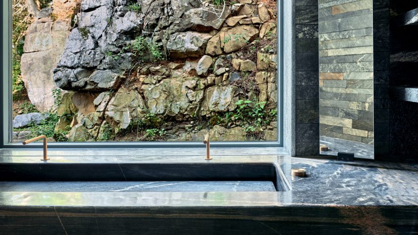 Studio Paolo Ferrari combines wood and granite for Canadian lake house
