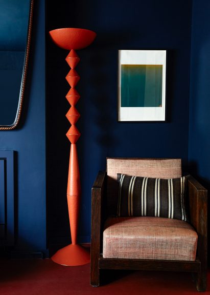 Red modular totem floor lamp made from stacked V-shaped parts from U/V Collection