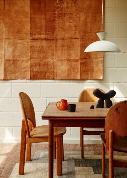 Sculptural white lamp by Palefire Studio hanging over brown table