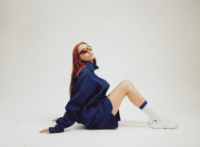 A woman wearing white Plastic Soul shoes