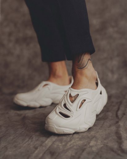 A pair of feet in white Rose In Good Faith shoes