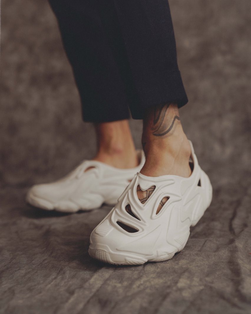 A pair of feet in white Rose In Good Faith shoes