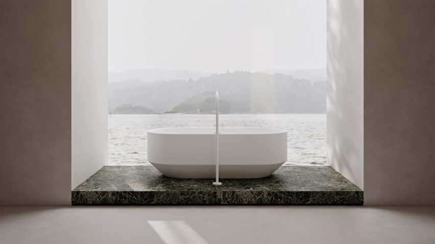 RYO freestanding bathtub on a green marble floor by a floor to ceiling window