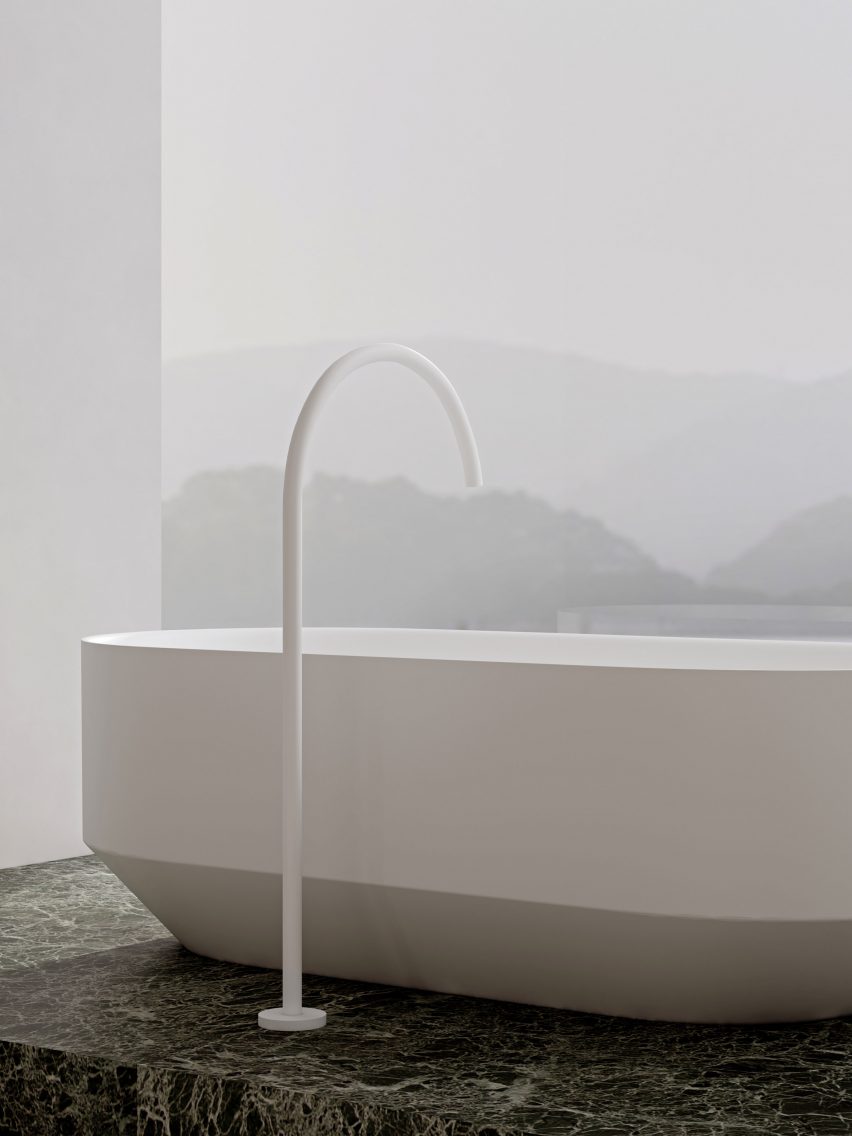 RYO freestanding bathtub on a green marble floor by a floor to ceiling window