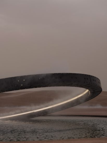 An illuminated ring is pictured rising from the circular pond by Es Devlin