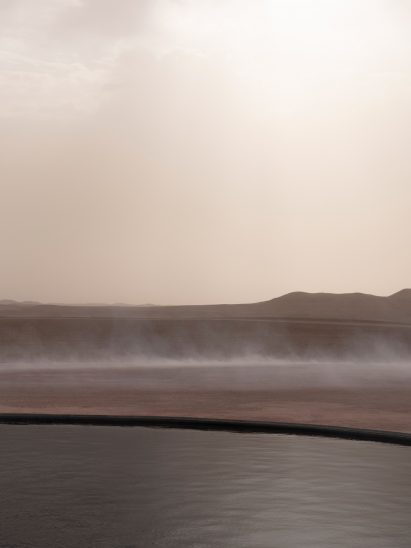 Mist clouds the Saint Laurent show space around a circular pond
