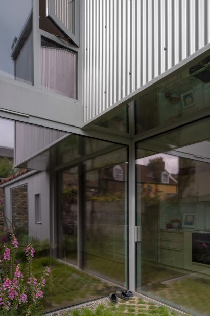 Corrugated metal cladding and reflective soffit