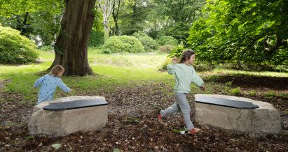 Children play around a sandstone bench designed by Dress for the Weather and Stefanie Cheong for Sitting Pretty