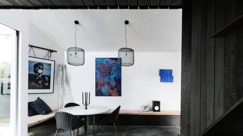 A dining area is painted black and white at Host House