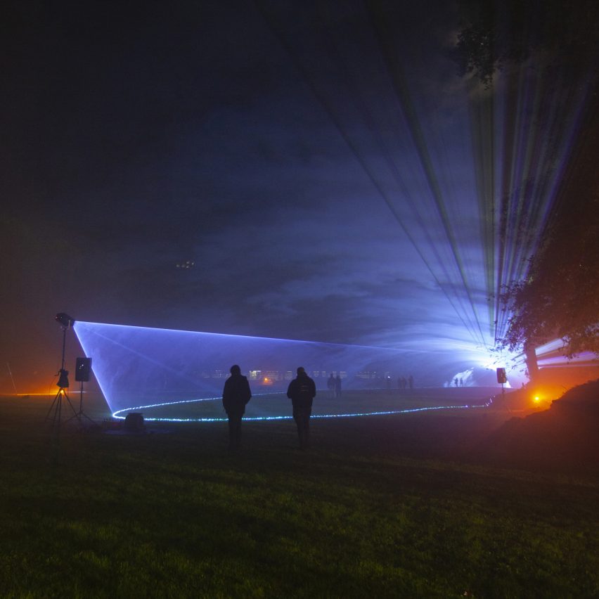 Photograph showing a dark space with light and figures