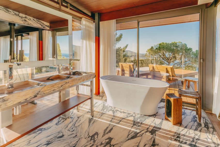 A marble hotel bathroom with freestanding bath