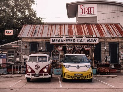 Volkswagen ID Buzz next to a vintage VW van in a parking lot