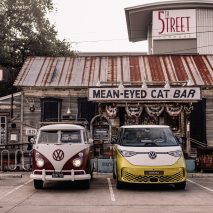 Volkswagen ID Buzz next to a vintage VW van in a parking lot