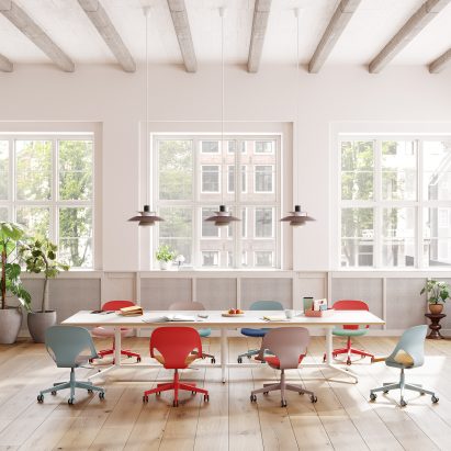Colourful Zeph chairs around a table in an open-plan office