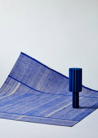 Image of blue object on top of blue tapestry