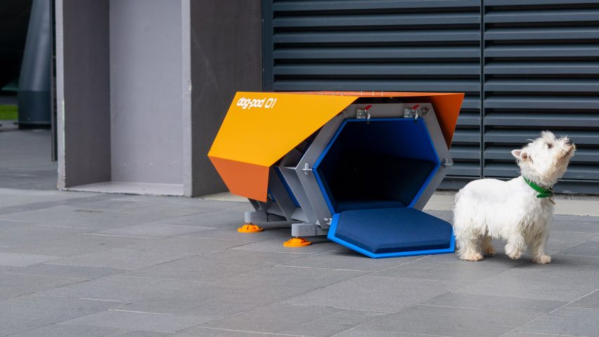A photograph of a dog besides a kennel, which is informed by Star Wars