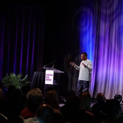 A photograph of a speaker talking at the International Design Conference 2022