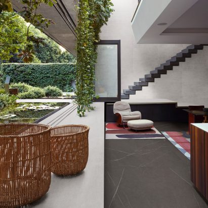Plant-filled apartment featuring Marazzi grey tiles