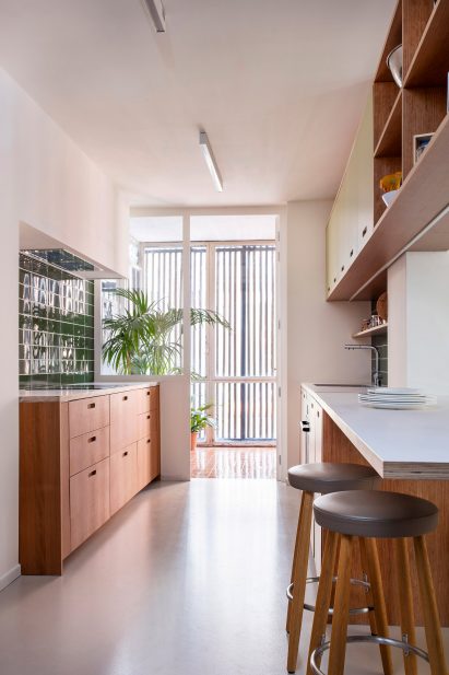 A kitchen with green tiles