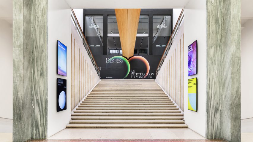 Photo of a stairwell and exhibition poster