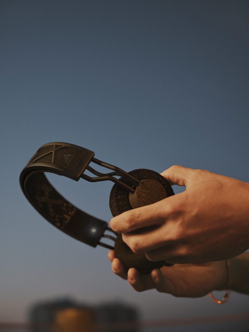 Hands holding a pair of headphones