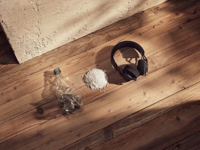 Headphones next to a plastic bottle