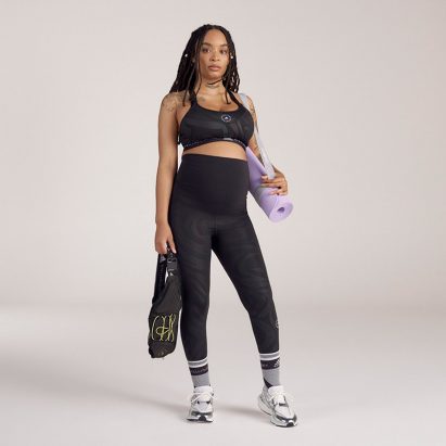 A woman in a matching sports bra and leggings