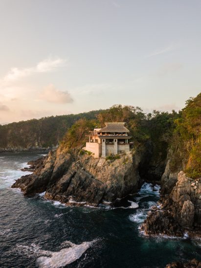 Cliffside home home with waves and forests