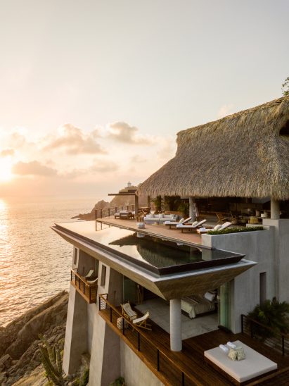 Cliffside pool with thatched roof
