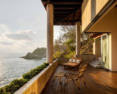 Terrace with columns and sea with lighthouse in the distance