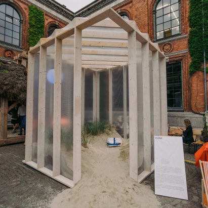 Greenhouse-like pavilion encloses Danish sand and plants to create “dynamic ecosystem”
