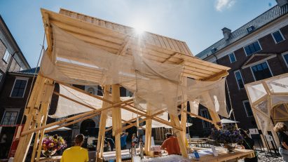 Eye level view of timber and hemp pavilion with guests using bar
